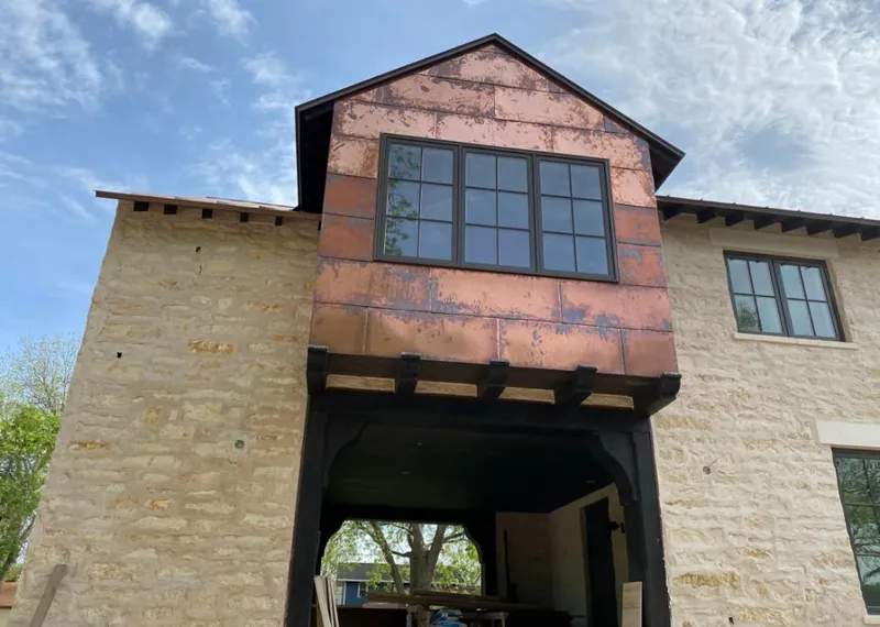 Copper metal panel facade on a stone building for Roof Repair in Atherton