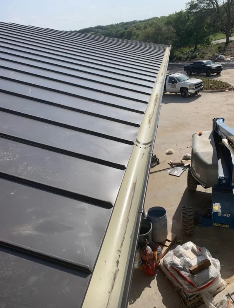Standing seam panel and gutter detail on a metal roofing jobsite in Atherton